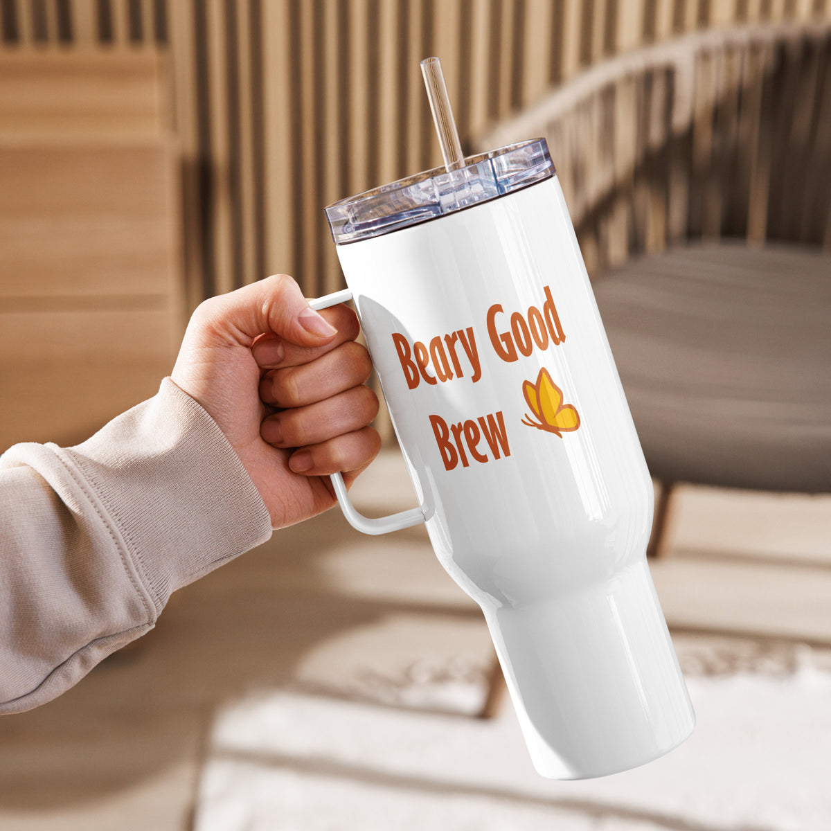 A 40 oz Beary Good Travel right-oriented mug held in the left hand to reveal the size of the 40 oz in one's hand and the "Beary Good Brew" text that faces away from the drinker.