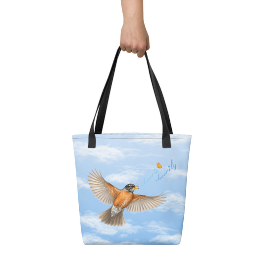 In-action product mockup, all-over print of Cheerily Robin Tote bag with black handles. The bag is being carried so that it can be seen face-on.