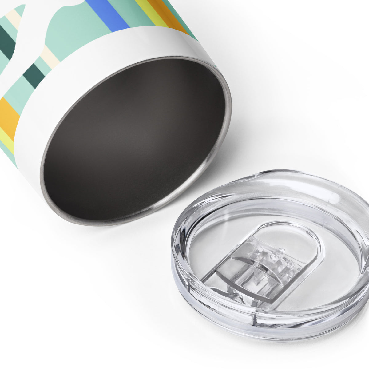 A Petals & Paws Cove Wine Tumbler laying on a white surface, on its side, to reveal the stainless steel interior. The tumbler sip-lid is sitting in front of the tumbler.