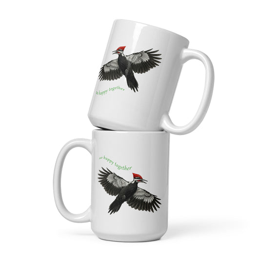 Product mock-up of two stacked 15 oz Pileated Woodpecker, So Happy Together, mugs. Shows front and back images as reflections of one another.