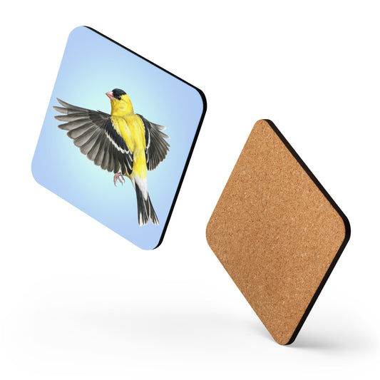 Two square American Goldfinch coasters appear to be dancing against a white background, one showing the goldfinch is flying against a clear blue sky on the front, while the other shows the cork on the back.