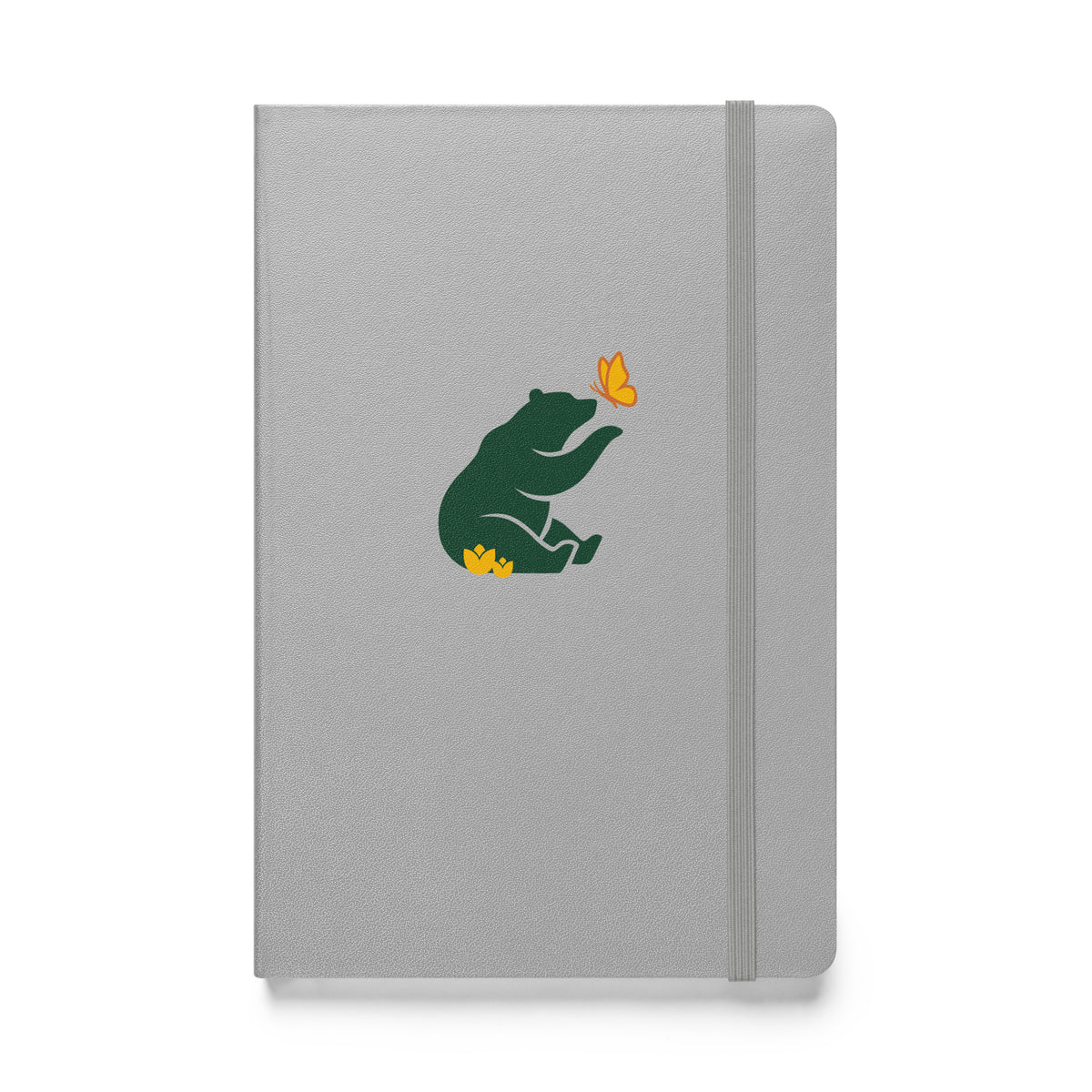 Flat-lay of gray (grey) notebook with green Petals & Paws bear graphic, sitting in yellow flowers with paw extended to yellow and orange butterfly.
