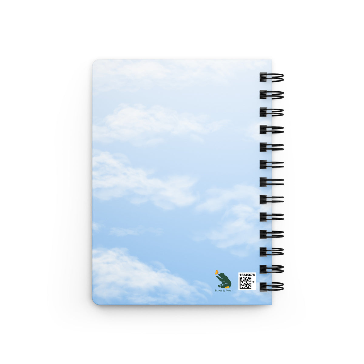 Product mockup of the back of spiral-bound Cheerily Robin Nature Journal.  The back is, all-over, a fair blue sky and fluffy cloud background. The Petals & Paws logo is in the bottom right corner.