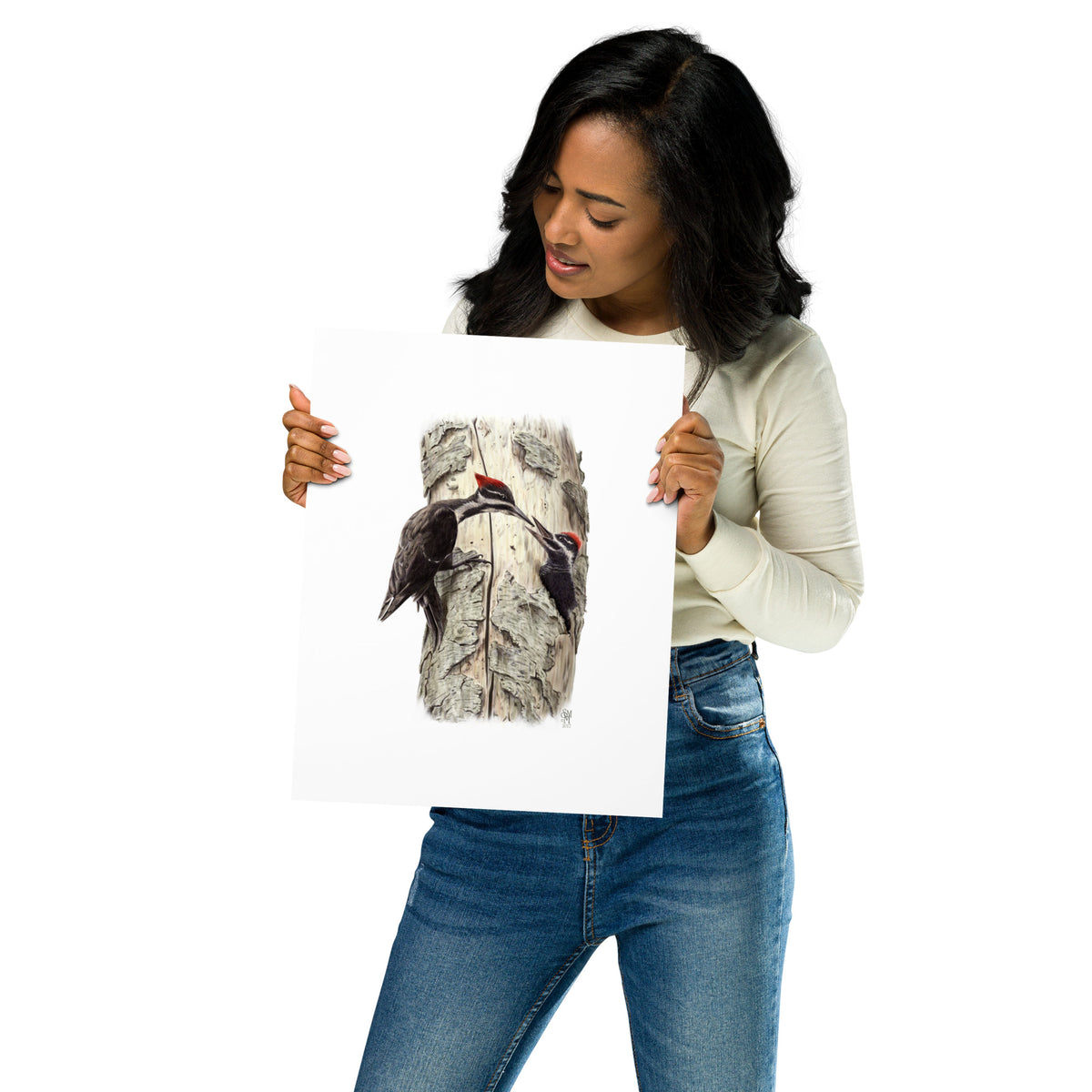 Person holding 11x14 inch museum-quality print of Coaxing Courage illustration of Pileated Woodpeckers to show relative size. Illustrated by Suzanne Matheson, 2017.