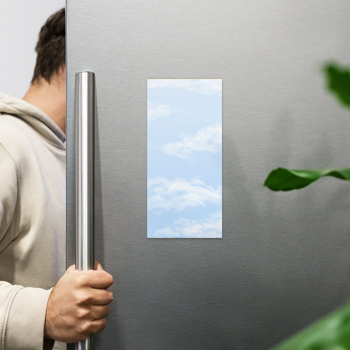 Fair Weather magnetic notepad, 4.25″ × 9″ (10.8 cm × 22.9 cm) displayed on fridge.  Overall design of fair blue sky with fluffy white clouds.