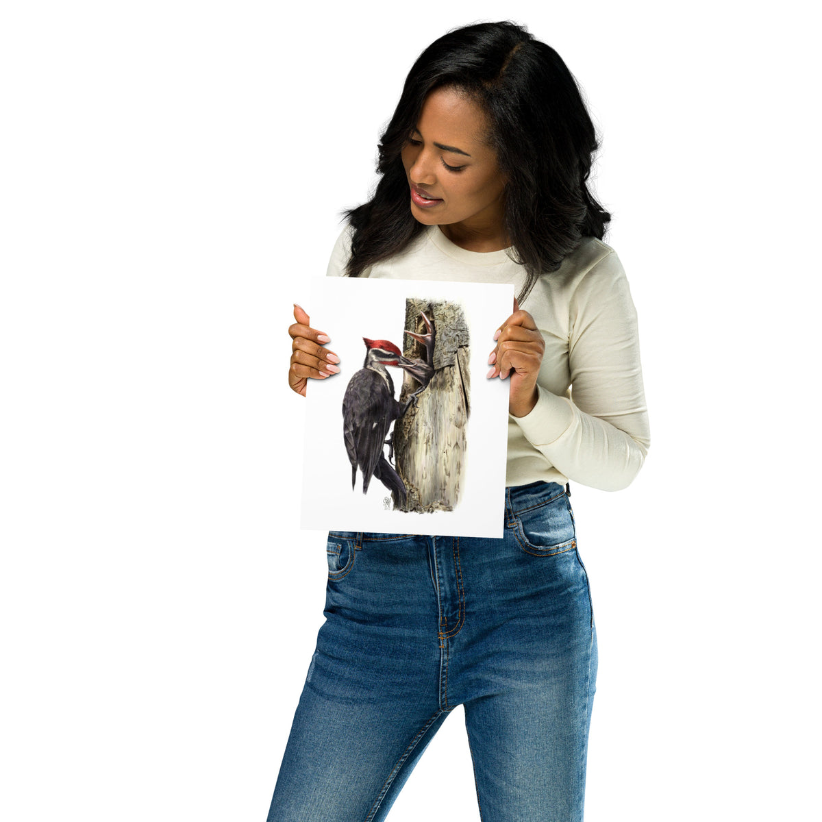 Person holding 8x10 inch museum-quality print of The Hungry Hour illustration of Pileated Woodpeckers to show relative size. Illustrated by Suzanne Matheson, 2017.