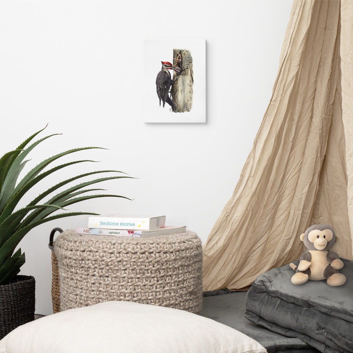 Gallery-wrapped canvas of The Hungry Hour, about Pileated Woodpecker parenting, hanging on a wall with surrounding home furnishings.  Illustrated by Suzanne Matheson, 2017.
