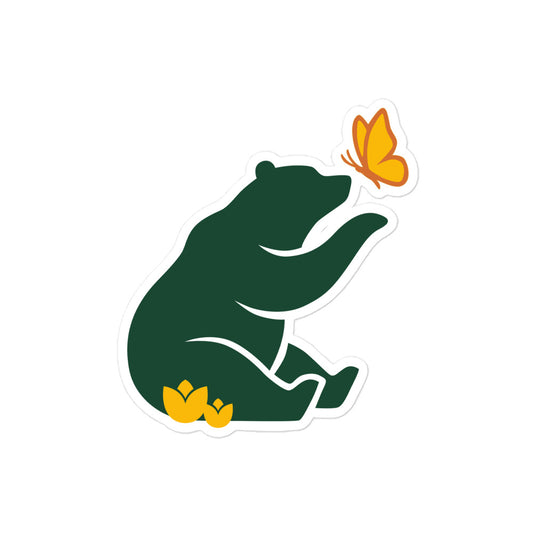 Product mockup of 4 inch wide Petals & Paws Beary kiss-cut sticker. This sticker features Petals & Paws forest green bear reaching for a yellow butterfly and sitting in yellow flowers.