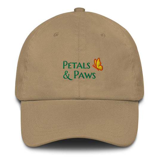 Product mockup of khaki Petals & Paws Classic Dad Hat.  This ball cap front features "Petals & Paws" in the brand's signature font, Marcellus SC, in green embroidery accented with the brands butterfly.