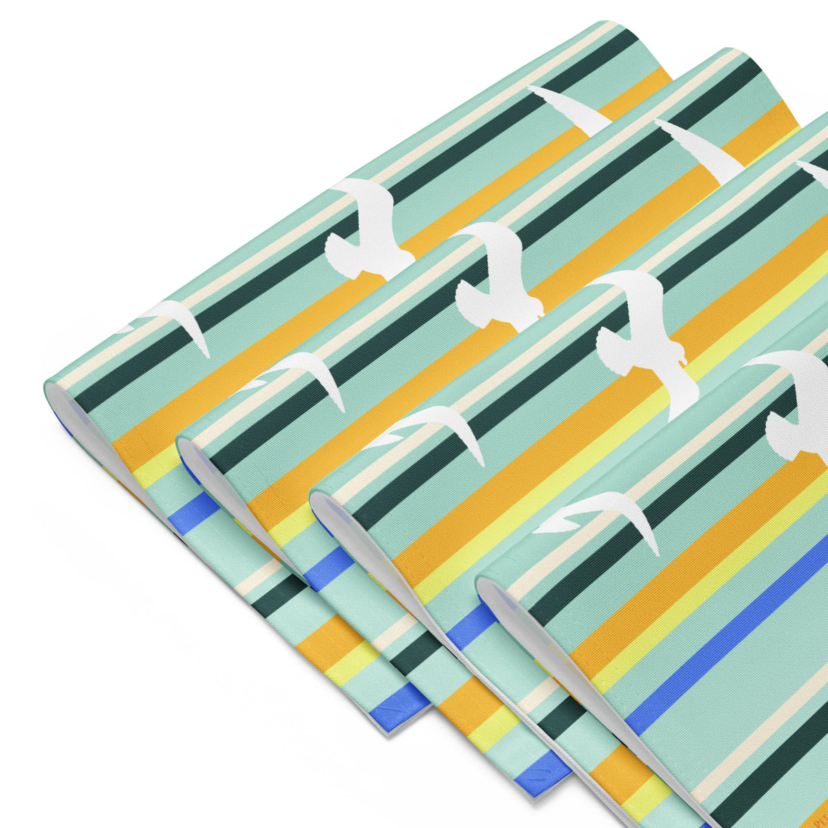 Product mockup of a Petals & Paws Cove Placemat, featuring seagull design with teal striped pattern. This image shows the full set of four.