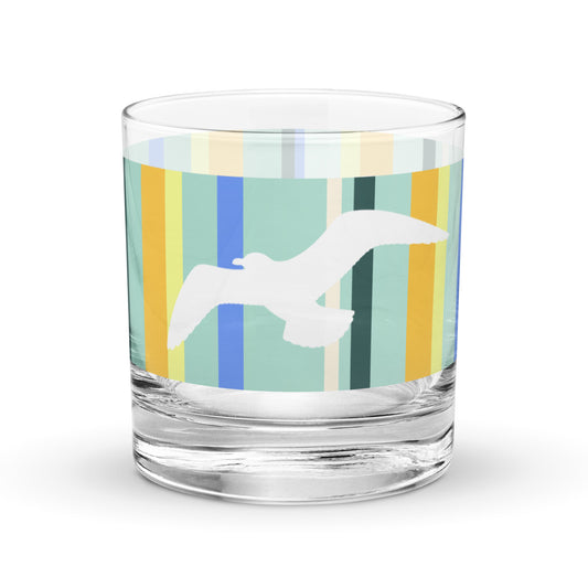 Product mockup of 10.5 oz Petals & Paws Cove Rocks Glass, featuring seagull design with teal striped pattern.