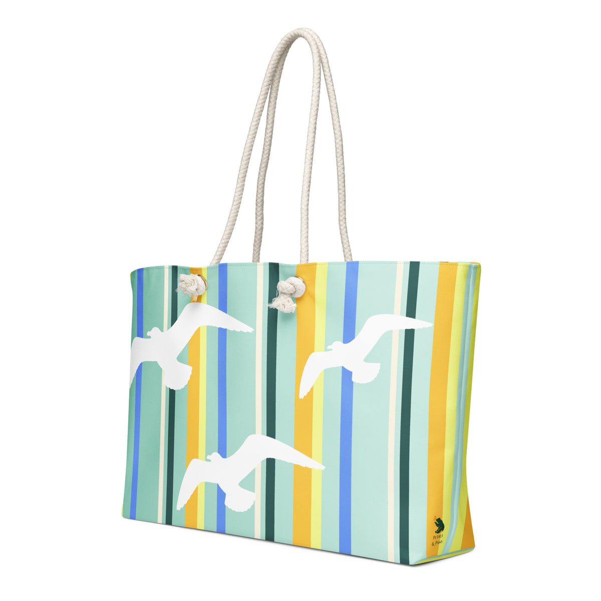 A diagonal view of Petals & Paws Cove Weekender Bag showing the pattern as it wraps around the ends of the bag, with the Petals & Paws logo near the bottom. This all-over print bag features seagull design with teal striped pattern and cream-colored cotton rope handles.