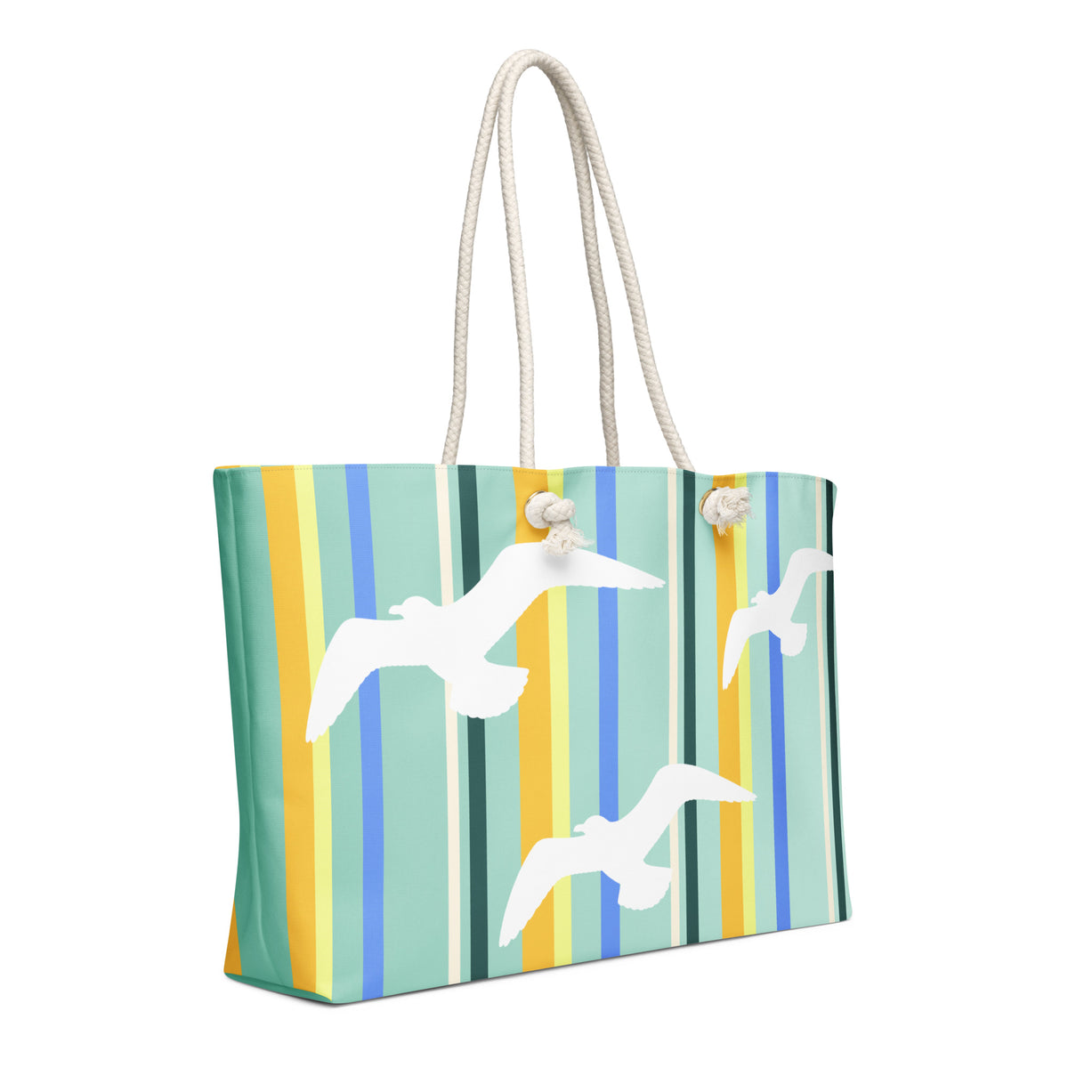 A diagonal view of Petals & Paws Cove Weekender Bag showing the pattern as it wraps around the ends of the bag. This all-over print bag features seagull design with teal striped pattern and cream-colored cotton rope handles.