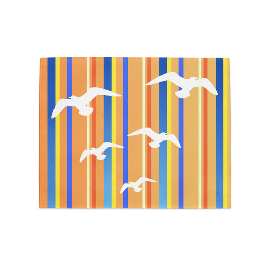Product mockup of a Petals & Paws Drift Placemat, featuring seagull design with orange striped pattern.