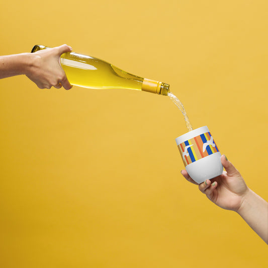 In-action mockup of Petals & Paws Drift Wine Tumbler, featuring seagull design with orange striped pattern. The hand of one person holds a bottle of wine, pouring it into the tumbler held by another person's hand. Background is an orange glow.