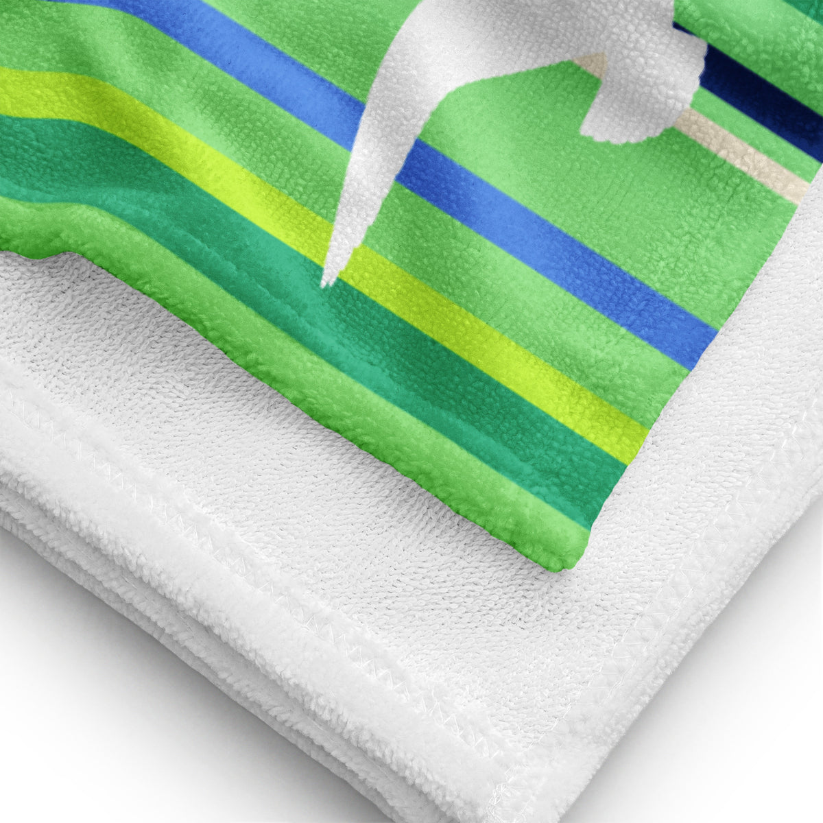A close-up view of folded 30 x 60" Petals & Paws Harbour Beach Towel, revealing the print of seagull design with green striped pattern on terry fabric and the white back surface.