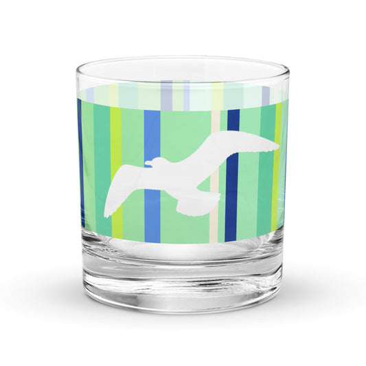Product mockup of 10.5 oz Petals & Paws Harbour Rocks Glass, featuring seagull design with green striped pattern.