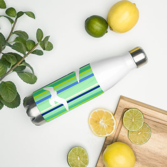 A 17 oz Petals & Paws Harbour Water Bottle laying on its side amidst citrus fruit and an herb plant. This bottle features seagull design with green striped pattern.