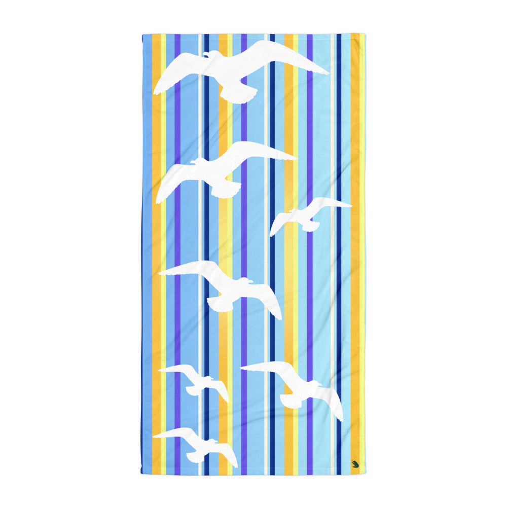 A flat-lay of 30 x 60" Petals & Paws Shoreline Beach Towel. This terry fabric towel features seagull design with blue striped pattern.