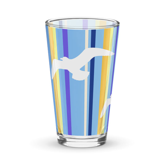 Product mockup of 16 oz Petals & Paws Shoreline Pint Glass, featuring seagull design with blue striped pattern.