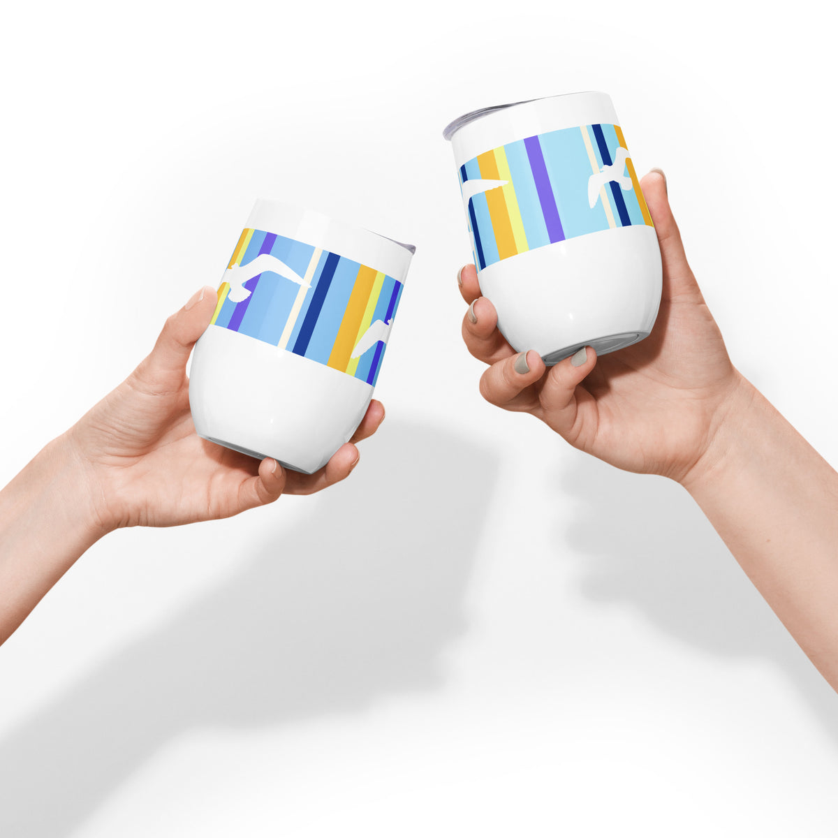 Two Petals & Paws Shoreline Wine Tumblers are each held in a hand, with the tumblers brought together in a "Cheers!" motion.