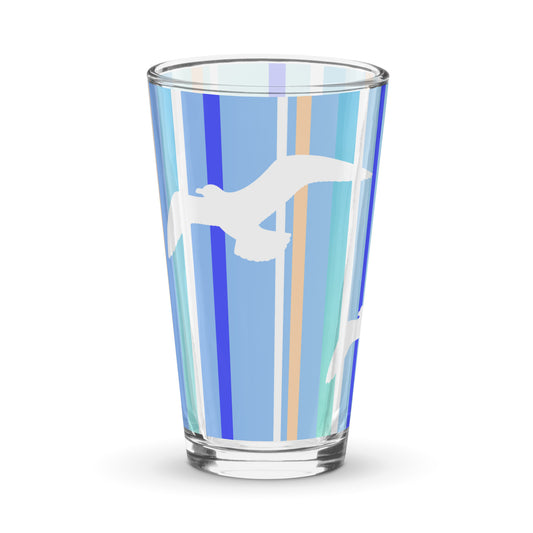 Product mockup of 16 oz Petals & Paws Tide Pint Glass, featuring seagull design with blue striped pattern.