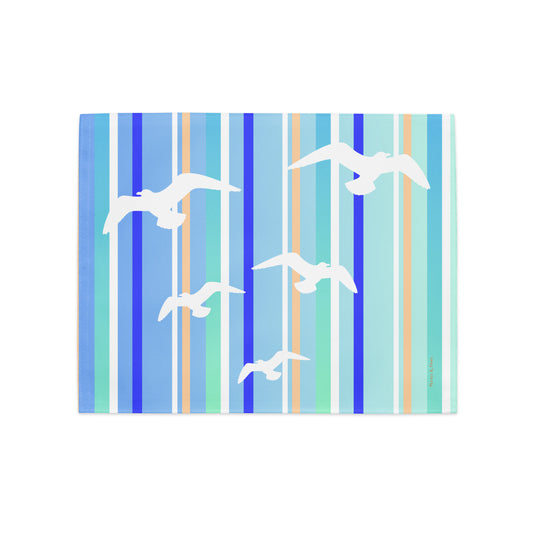 Product mockup of a Petals & Paws Tide Placemat, featuring seagull design with blue striped pattern.