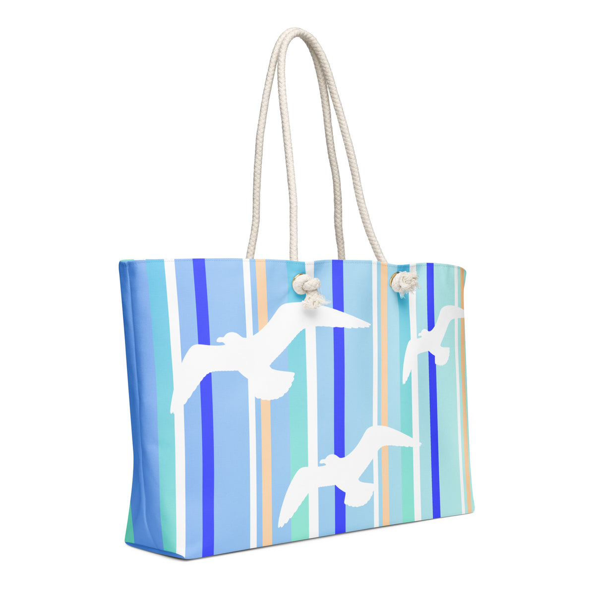 A diagonal view of Petals & Paws Tide Weekender Bag showing the pattern as it wraps around the ends of the bag. This all-over print bag features seagull design with blue striped pattern and cream-colored cotton rope handles.