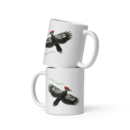 Product mock-up of two stacked 11 oz Pileated Woodpecker, So Happy Together, mugs. Shows front and back images as reflections of one another. 