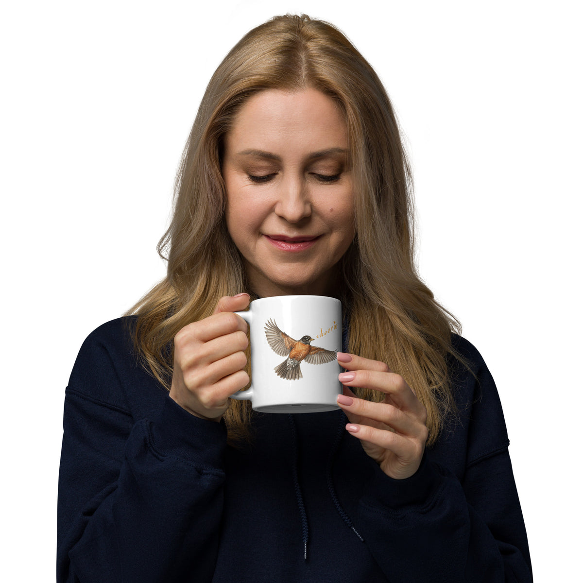A woman holds and looks into 11 oz Robin Discovery Ceramic Mug.  Front design of realistic flying robin, "cheerio," set against a dark sweater.