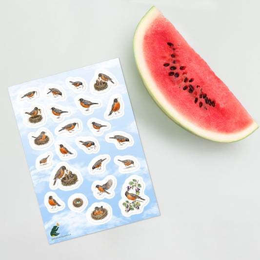 A sheet of kiss-cut stickers featuring illustrated American robins nesting and foraging, with a background of fair blue sky, placed next to a slice of watermelon.