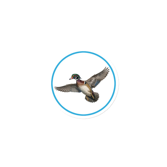 Product mockup of Wood Duck Circular Magnet, a 3" die-cut magnet featuring a realistic duck within a blue circle.